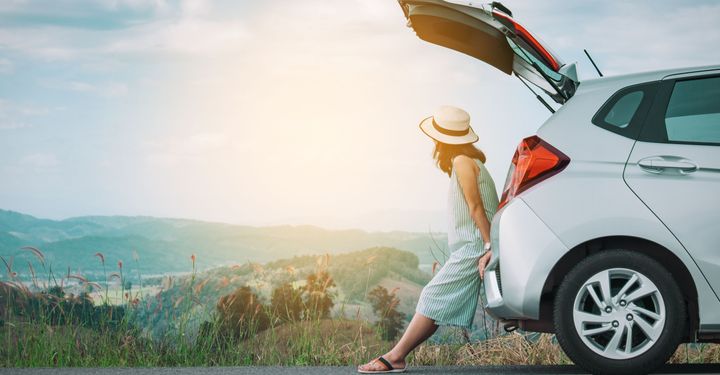 woman leaning on boot of a car