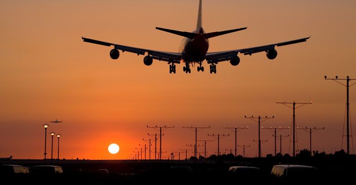  Plane landing in LAX airport at sunset 