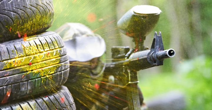 Man shooting a paintball gun