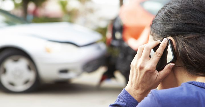 woman calling car hire company after accident