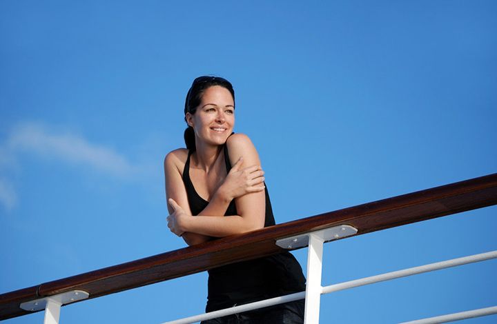 woman relaxing on ship deck
